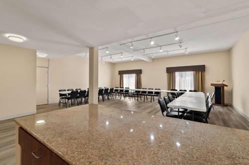 a conference room with a table and chairs in it at Ramada by Wyndham Harrisburg/Hershey Area in Harrisburg