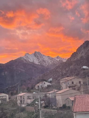 a view of a town with snow capped mountains at À casetta in Albertacce