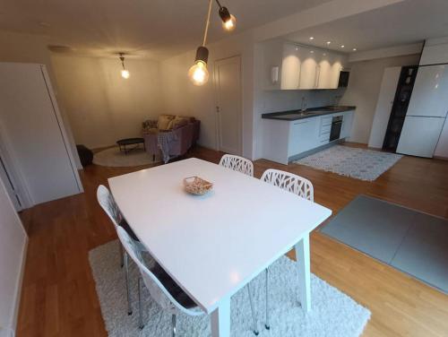a white table and chairs in a living room at Modern, private & fully equipped for 3 & 2 children, near forest, with kitchen washer, pets friendly in Floda
