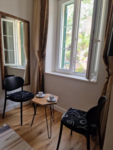 a room with two chairs and a table and a window at Old Town Apartment in Omiš