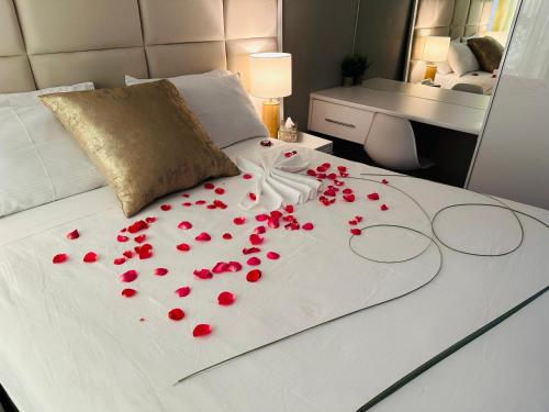 a bunch of red roses laying on a bed at Kings View Exclusive Villas (KVEV) in Petronella