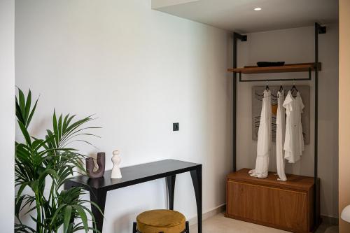 a dressing room with a table and a mirror at Theta Boutique Hotel in Chania