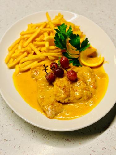 a plate of food with pasta and french fries at Landgasthof Hotel Rebstock in Stühlingen