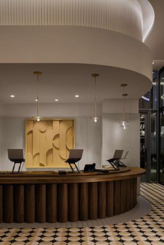 a lobby with a counter with two laptops on it at Motto By Hilton New York City Times Square in New York