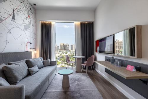 a living room with a couch and a table at Ink Hotel in Dubai