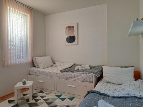 two twin beds in a room with at Saint Nicholas Varna Lovely 2 bedroom apartment with sunny garden in Varna City