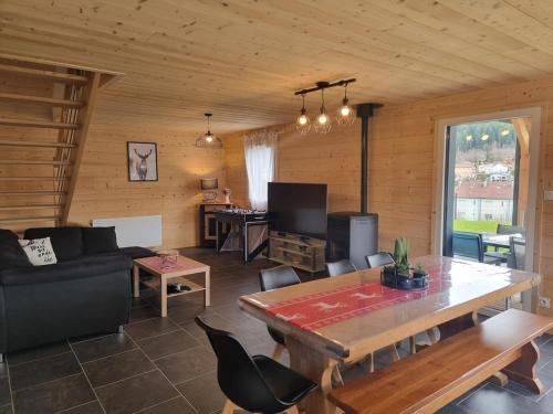 a living room with a couch and a table at Le nid de Claude et Nadine in Gérardmer