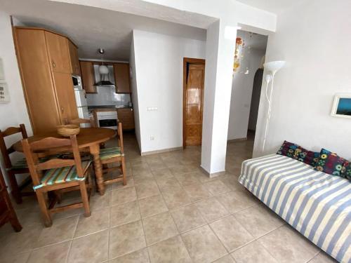 a kitchen and dining room with a table and a couch at Apartamento Mare Nostrum Centro Aguamarga in Agua Amarga