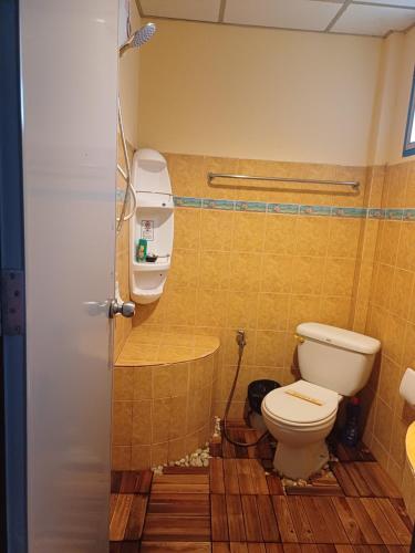 a bathroom with a toilet and a sink at Tropicana Khophagan Resort Hotel in Thong Sala