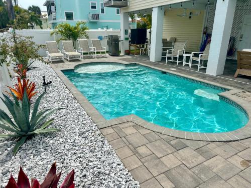 a swimming pool in the backyard of a house at Sunshine retreat Elevated New Build walkable to everything including BEACH in Fort Myers Beach