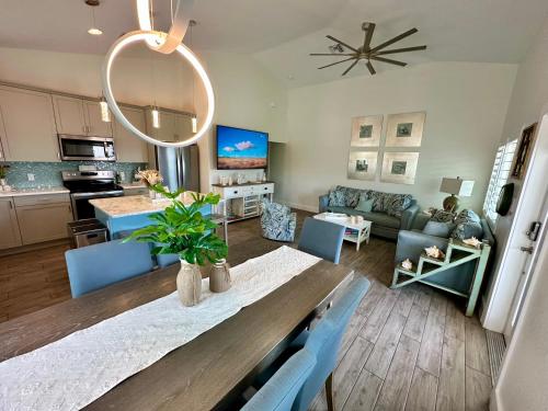 a kitchen and living room with a table and chairs at Sunshine retreat Elevated New Build walkable to everything including BEACH in Fort Myers Beach