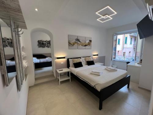 a bedroom with a bed and a large window at Affittacamere Sull'Arco in Monterosso al Mare