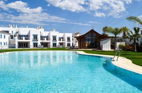 a large swimming pool in front of a house at Paraiso Pueblo in Benahavís