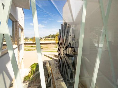 a view of a building through a window at 5ª Vigia in Porto de Mós