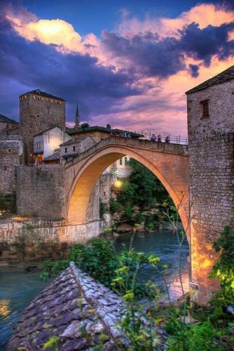 a bridge over a river with people walking on it at Apartman Antony in Čitluk