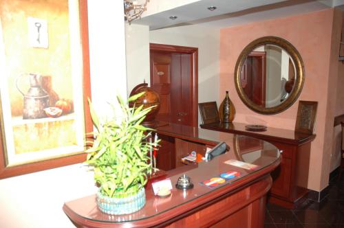 a bathroom with a sink and a mirror at Villa Mia Suites in Ohrid