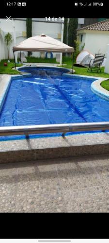 una grande piscina blu con ombrellone di Casa en el centro a Aguascalientes