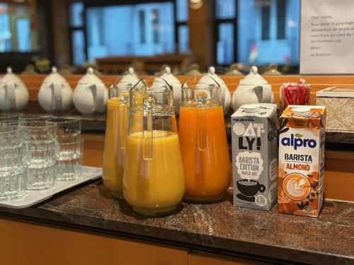 a group of glasses of orange juice on a counter at Liberty in Blankenberge