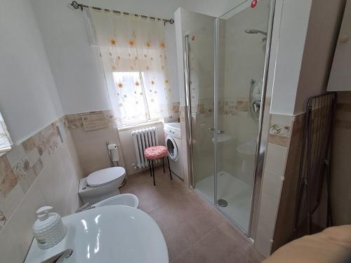 a bathroom with a shower and a toilet and a sink at CASA VACANZE L'OLIVO in Lubriano