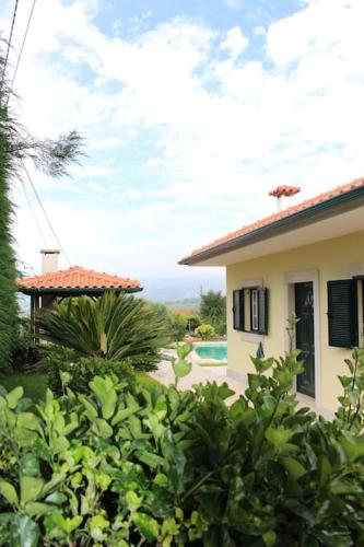 a house with a view of a yard at Casa das Leiras - Mondim de Basto in Mondim de Basto