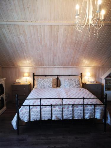 a bedroom with a bed with a wooden ceiling at Countryhouse Lake Attersee - Traumhaft schöne Lage - Bezauberndes Hideaway in Unterach am Attersee