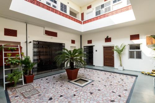 a large room with a courtyard with potted plants at Heart of the City Homestay by Rashmi in Jaipur