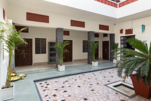 a courtyard of a house with palm trees at Heart of the City Homestay by Rashmi in Jaipur