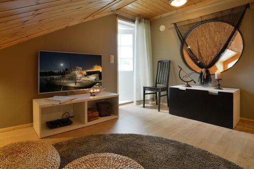 a living room with a large screen tv on a wall at Vuokatin Aateli Apartments in Vuokatti