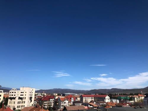 a city skyline with buildings and a blue sky at TIF Studio in Râmnicu Vâlcea