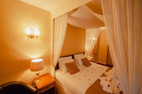 a hotel room with a bed and a window at Howfield Manor Hotel in Canterbury