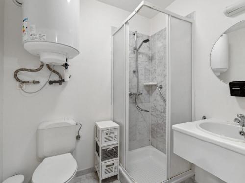 a bathroom with a shower and a toilet and a sink at Ocean Suites on floor 10 in Blankenberge