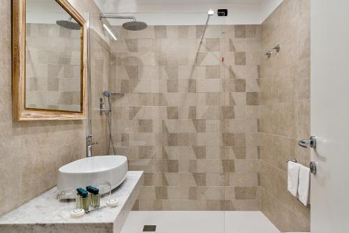 a bathroom with a sink and a shower at Hotel Excelsior in Marina di Massa