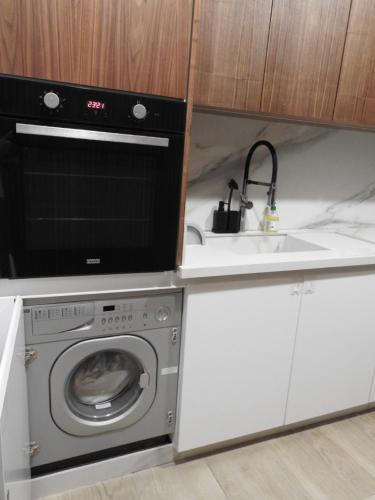 a kitchen with a washing machine and a sink at Anfa Place, Luxury Apartment just renovated, Ocean View in Casablanca