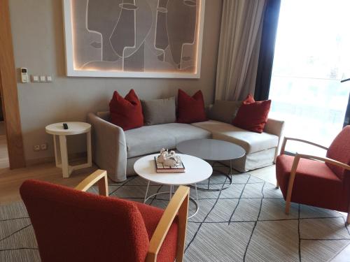 a living room with a couch and two tables at Anfa Place, Luxury Apartment just renovated, Ocean View in Casablanca