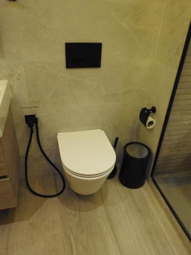 a bathroom with a toilet and a trash can at Anfa Place, Luxury Apartment just renovated, Ocean View in Casablanca