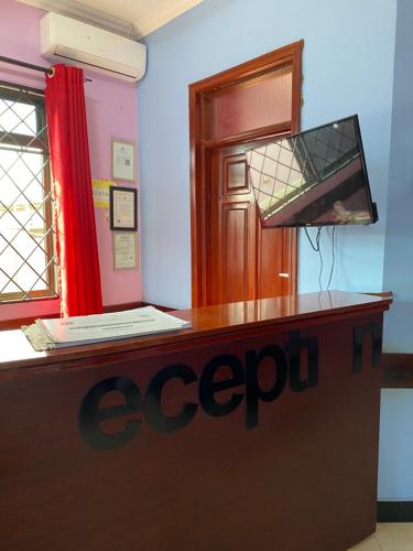 ein Büro mit einem Schreibtisch mit einem Schild darauf in der Unterkunft Makidonia Lodge in Daressalam