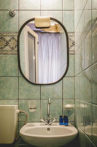 a bathroom with a sink and a mirror at pension Acronafplia - classic in Nafplio