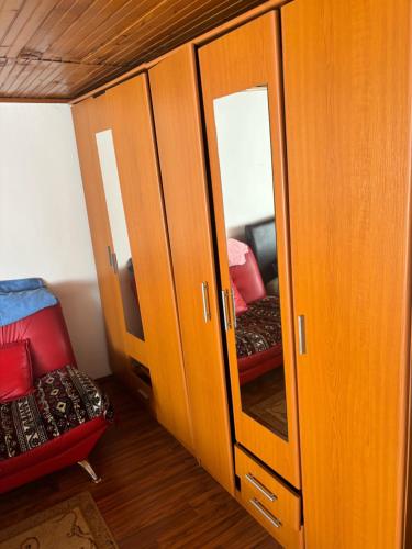 a cabinet with a mirror and a chair in a room at Miky Apartments in Podgorica