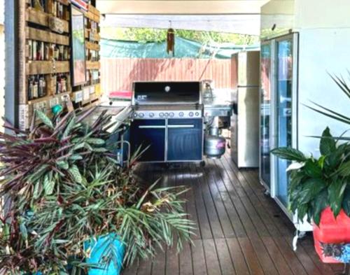 a kitchen with a stove and some plants at Island Room in Horseshoe Bay on Magnetic Island in Horseshoe Bay