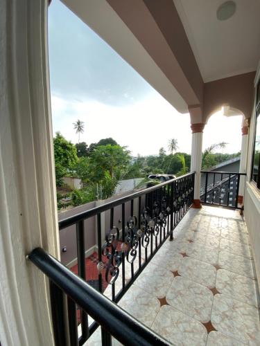 a balcony with a view of the ocean at Magdon Lodge in Dar es Salaam