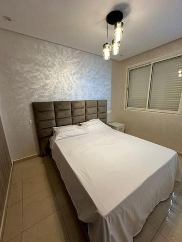 een slaapkamer met een groot wit bed in een kamer bij Luxury appart securise avec piscine in Agadir
