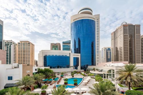 a view of a city skyline with a blue building at Le Royal Meridien Abu Dhabi in Abu Dhabi