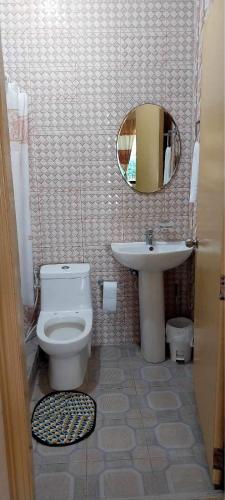 a bathroom with a toilet and a sink at Cody Homestay in Burgos