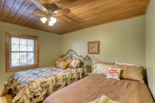 a bedroom with two beds and a ceiling fan at Rocky Ridge Lodge in Lead