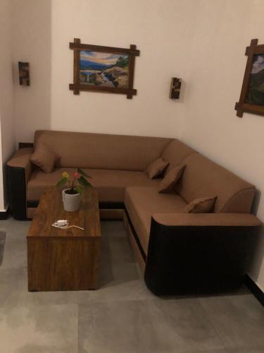 a living room with a couch and a coffee table at Eagle View villa in Ella