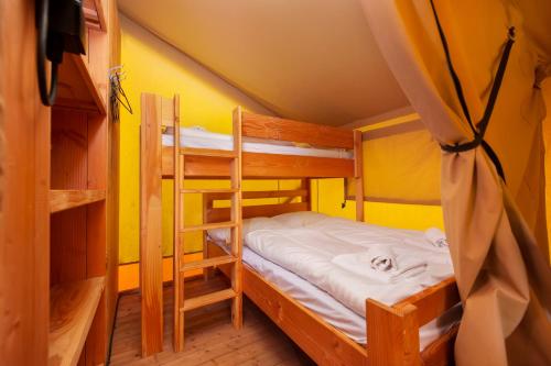 a bedroom with two bunk beds in a room at Glamping and Mobile Homes Lavanda - Holiday Centre Bi VIllage in Fažana