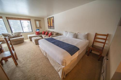 a bedroom with a large bed and a couch at Mall 1421 in Keystone