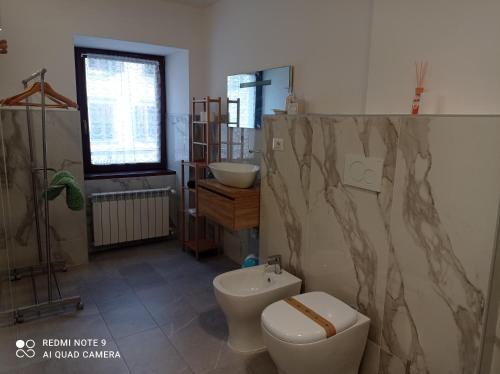 a bathroom with a toilet and a sink at Sweet Home in Tolmezzo