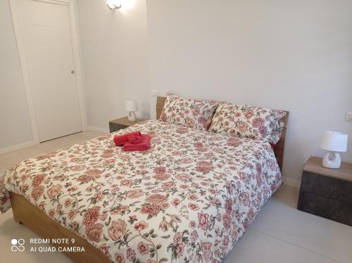 a bedroom with a bed with a red shirt on it at Sweet Home in Tolmezzo