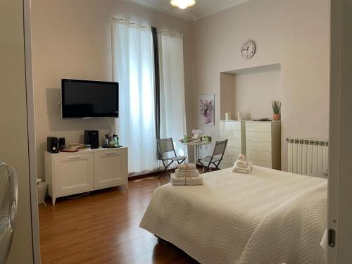 a bedroom with a bed and a table and a tv at B&B Home XIX in Narni